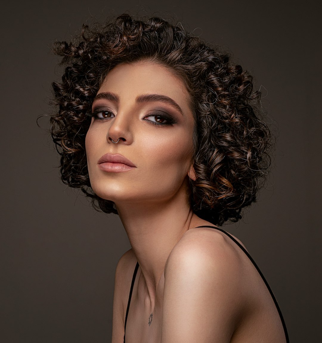 Portrait of a woman journalist with curly hair